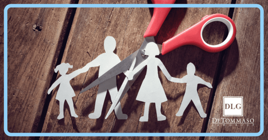 paper family being cut in half by scissors