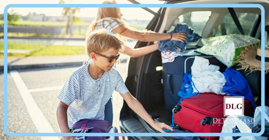 family packing car up for vacation