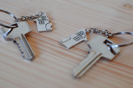 Two keys with half of a broken house key chain