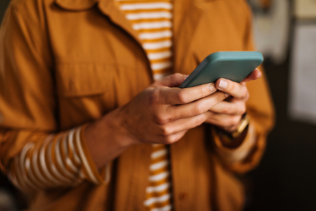 closeup of person typing on their phone