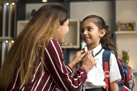 mother helping child get ready for school